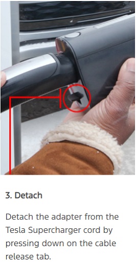 Detach the adapter from the Tesla Supercharger cord by pressing down on the cable release tab.