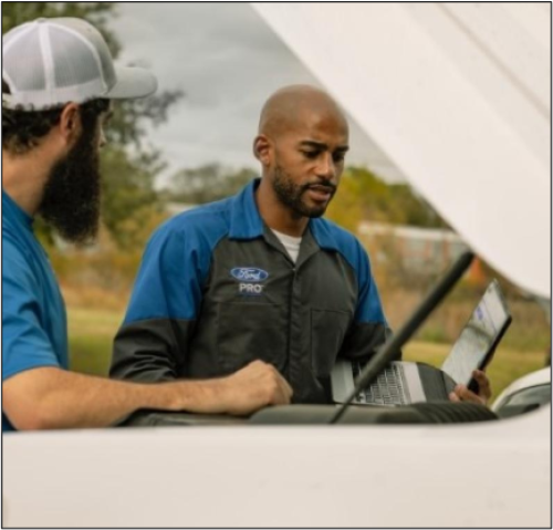 Roadside representative working outside diagnosing vehicle.