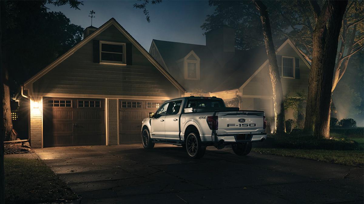A Ford F-150 truck is parked in a residential driveway.