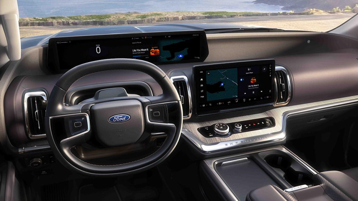 The Ford Digital Experience appears on the in-vehicle screens of a Ford Expedition® SUV parked at a scenic seascape.