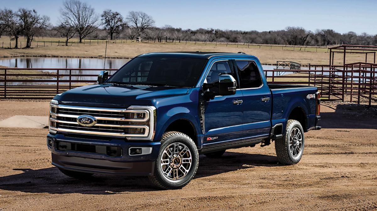A Platinum® Plus Super Duty® pickup is parked on the ranch in front of a corral.