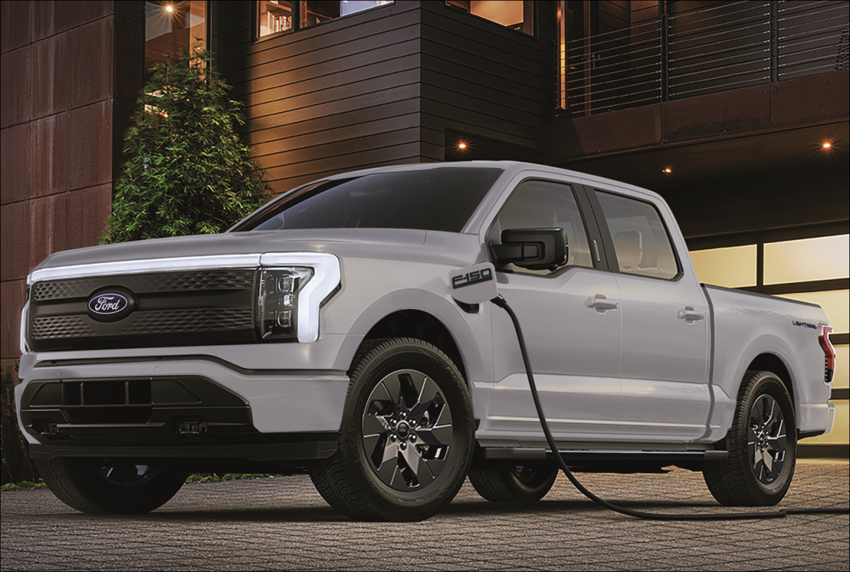 An F-150 Lightning charging outside a home.