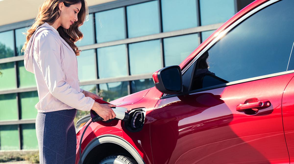 An owner plugs in their plug-in hybrid at home.
