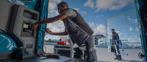 An owner charging up several work tools at once, using Pro Power Onboard sockets in the cargo area.