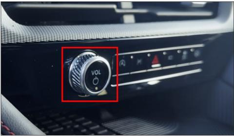 Radio Volume/Power button on center console below the touchscreen emphasized in a red box.
