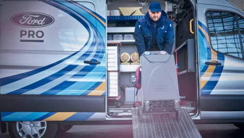 Mobile Service technician, carrying equipment out of a Mobile Service Van.