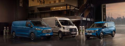 Image of a E-Transit Custom, E-Transit and E-Transit Courier lined up in a room surrounded by Ford Pro chargers.