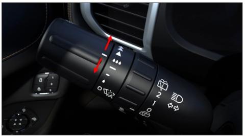 Windshield wiper stalk with arrows on dial at end of stalk indicating it should be twisted up or down.