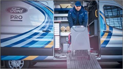 Mobile Service technician, carrying equipment out of a Mobile Service van.